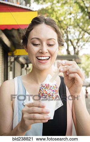Thai woman eating ice cream in city View Large Photo Image Stock Image - Thai woman eating ice cream in city. Fotosearch