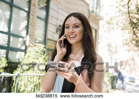 Thai woman shopping on cell phone with credit card View Large Photo Image Stock Photography - Thai woman shopping on cell phone with credit card. Fotosearch