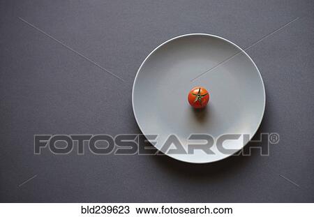 Tomato on white plate View Large Photo Image Stock Image - Tomato on white plate. Fotosearch