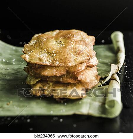 Stock Photograph - Tostones on banana leaf. Fotosearch