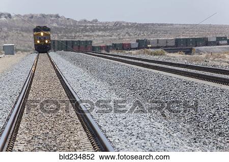 Train approaching on railroad track View Large Photo Image Stock Image - Train approaching on railroad track. Fotosearch