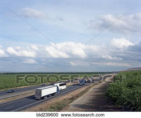 Trucks and cars driving on freeway View Large Photo Image Stock Image - Trucks and cars driving on freeway. Fotosearch