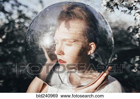 Stock Photo - Unusual Caucasian teenage girl wearing glass helmet on head. Fotosearch