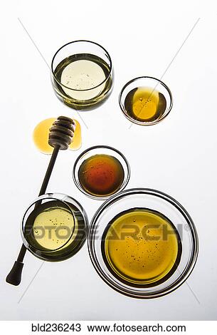Stock Image - Variety of honey in bowls. Fotosearch
