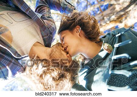 View from below of Caucasian couple kissing View Large Photo Image Stock Photo - View from below of Caucasian couple kissing. Fotosearch