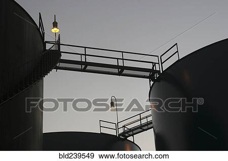 Stock Photo - Walkway between storage tanks. Fotosearch