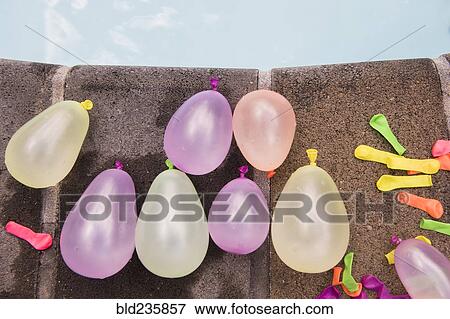 Water balloons at the edge of swimming pool View Large Photo Image Stock Photo - Water balloons at the edge of swimming pool. Fotosearch