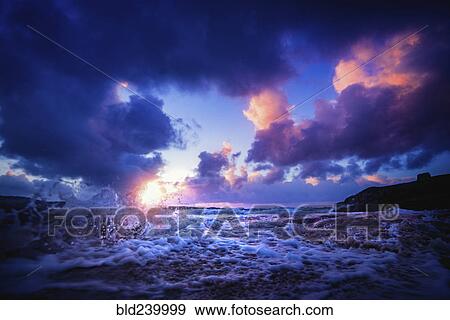Waves splashing at sunset View Large Photo Image Stock Photo - Waves splashing at sunset. Fotosearch
