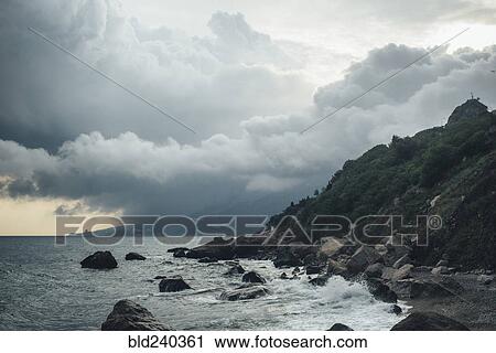 Waves splashing on rocky beach View Large Photo Image Stock Image - Waves splashing on rocky beach. Fotosearch
