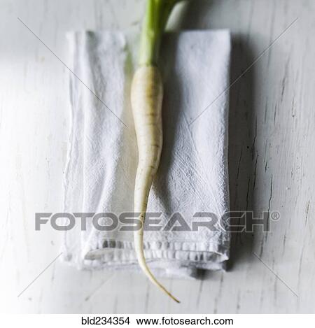 White carrot on napkin on white wooden table View Large Photo Image Picture - White carrot on napkin on white wooden table. Fotosearch