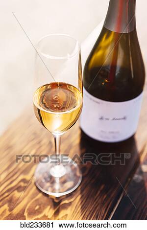Stock Image - White wine in glass with bottle. Fotosearch