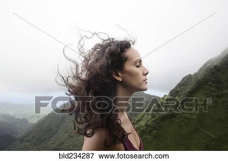 Stock Photo - Wind blowing hair of Mixed Race woman. Fotosearch