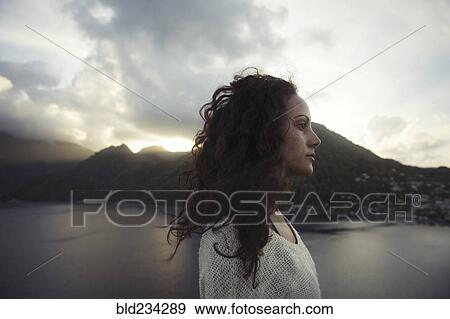 Wind blowing hair of Mixed Race woman near lake View Large Photo Image Stock Photo - Wind blowing hair of Mixed Race woman near lake. Fotosearch