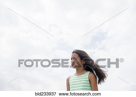 Wind blowing hair of serious Mixed Race girl View Large Photo Image Stock Photo - Wind blowing hair of serious Mixed Race girl . Fotosearch
