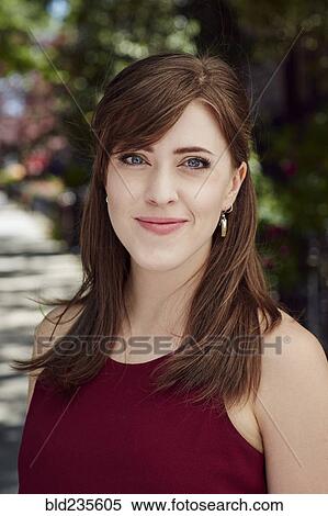 Stock Photography - Wind blowing hair of smiling Caucasian woman. Fotosearch