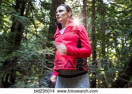 Woman running in forest View Large Photo Image Picture - Woman running in forest. Fotosearch
