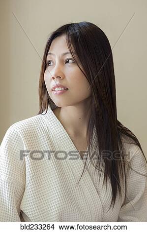Woman wearing white robe looking away View Large Photo Image Picture - Woman wearing white robe looking away. Fotosearch