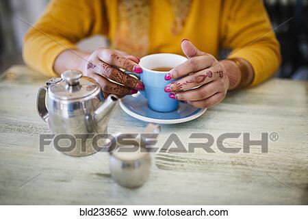 Woman with henna tattoo on hands drinking tea View Large Photo Image Stock Image - Woman with henna tattoo on hands drinking tea. Fotosearch