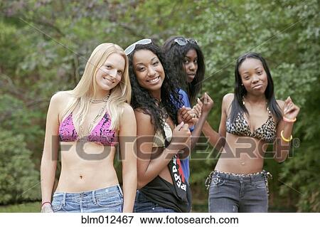 Women hanging out together in bikini tops View Large Photo Image Stock Photo - Women hanging out together in bikini tops. Fotosearch