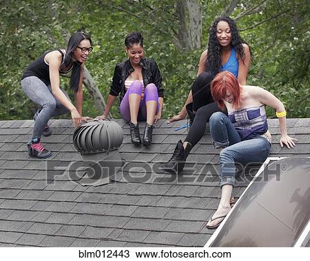 Women hanging out together on rooftop View Large Photo Image Stock Image - Women hanging out together on rooftop. Fotosearch