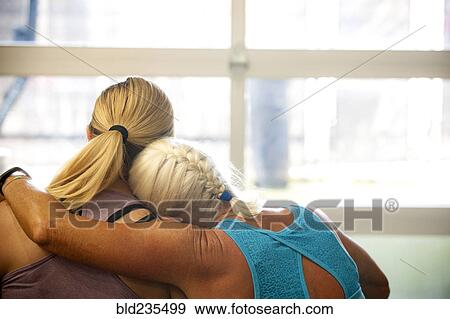 Stock Photo - Women hugging. Fotosearch
