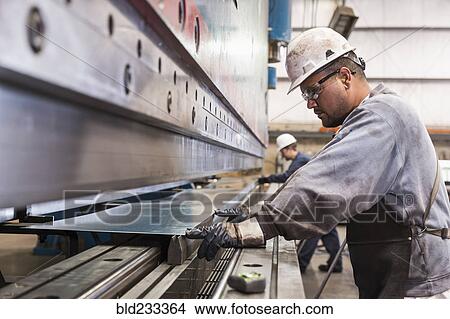 Workers fabricating metal in factory View Large Photo Image Picture - Workers fabricating metal in factory. Fotosearch