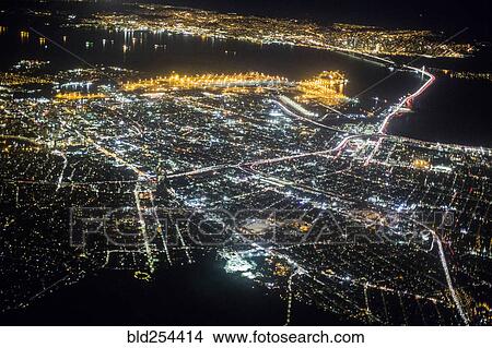 Aerial view of illuminated city at night View Large Photo Image Picture - Aerial view of illuminated city at night. Fotosearch