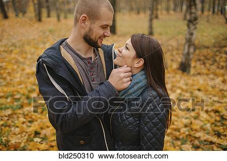 Stock Image - Affectionate Middle Eastern couple in park in autumn. Fotosearch