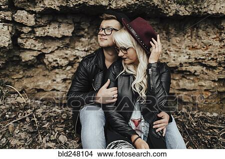 Picture - Affectionate Middle Eastern couple cuddling near rocks. Fotosearch