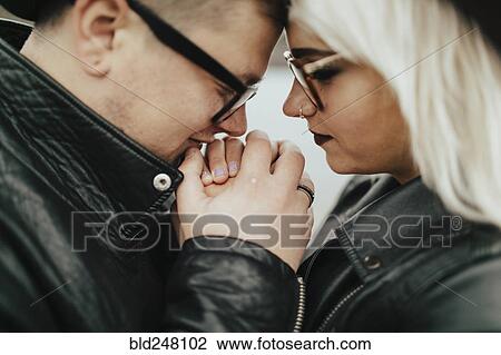 Stock Image - Affectionate Middle Eastern couple holding hands. Fotosearch
