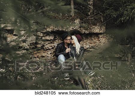 Stock Photography - Affectionate Middle Eastern couple kissing near rocks. Fotosearch