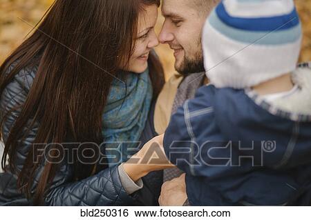 Stock Photograph - Affectionate Middle Eastern couple with baby son. Fotosearch