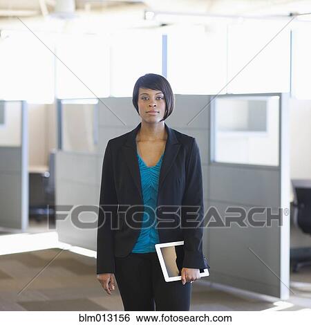 African American businesswoman holding digital tablet in office View Large Photo Image Stock Photograph - African American businesswoman holding digital tablet in office. Fotosearch