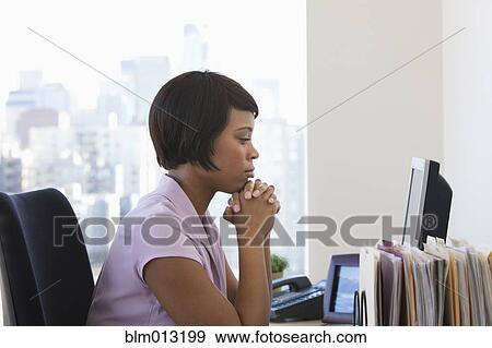 African American businesswoman looking at computer View Large Photo Image Stock Photo - African American businesswoman looking at computer. Fotosearch