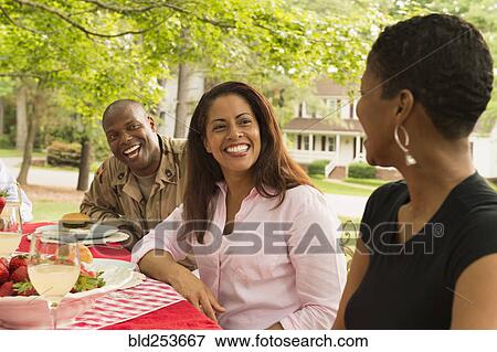 African American man and women laughing at picnic View Large Photo Image Stock Photo - African American man and women laughing at picnic. Fotosearch
