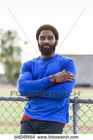 African American man leaning on fence View Large Photo Image Picture - African American man leaning on fence. Fotosearch