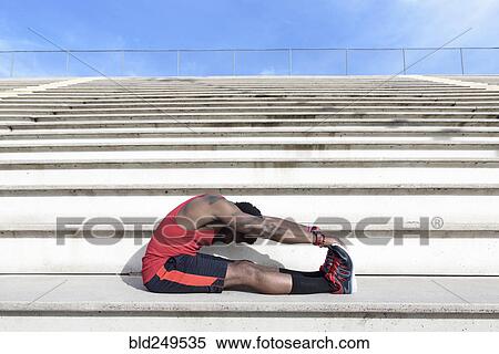 African American man stretching legs on bleachers View Large Photo Image Stock Photography - African American man stretching legs on bleachers. Fotosearch