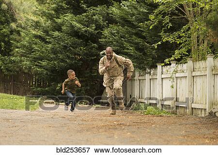 Stock Photo - African American soldier running in race with son. Fotosearch