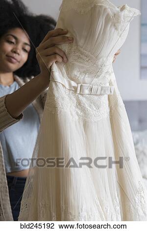 African American Woman Holding Wedding Dress Stock Image