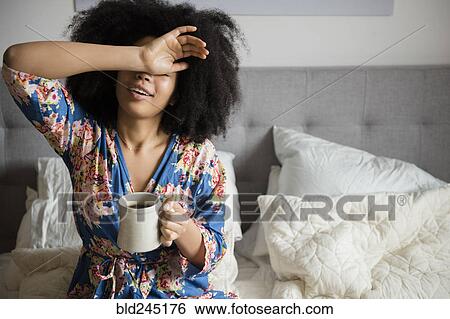 African American woman sitting in bed drinking coffee View Large Photo Image Stock Photograph - African American woman sitting in bed drinking coffee. Fotosearch