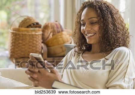 African American woman texting on cell phone View Large Photo Image Stock Photo - African American woman texting on cell phone. Fotosearch