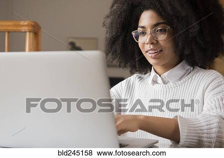 African American woman using laptop View Large Photo Image Stock Photo - African American woman using laptop. Fotosearch