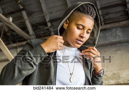 Picture - Androgynous Mixed Race woman wearing hood. Fotosearch