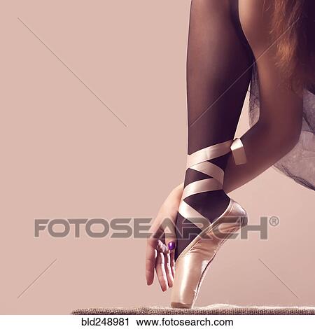 Stock Image - Arm and leg of Caucasian ballerina. Fotosearch