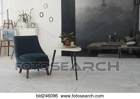 Stock Photograph - Armchair and table in livingroom. Fotosearch