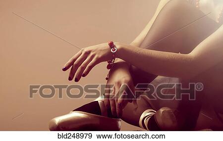 Stock Photo - Arms and legs of Caucasian ballerina sitting on floor. Fotosearch