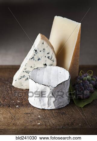 Artisanal cheese and grapes on wooden table View Large Photo Image Stock Image - Artisanal cheese and grapes on wooden table. Fotosearch