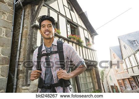 Stock Photo - Asian man backpacking in city. Fotosearch