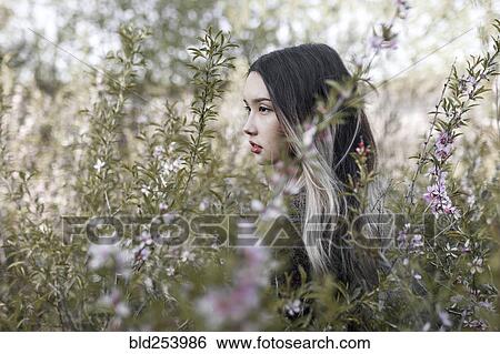 Asian teenage girl standing in flowers View Large Photo Image Stock Photograph - Asian teenage girl standing in flowers. Fotosearch