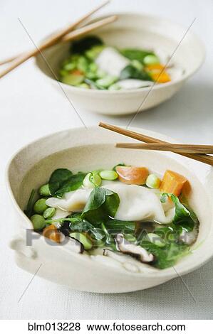 Stock Photo - Asian vegetable soup in bowls with chopsticks. Fotosearch